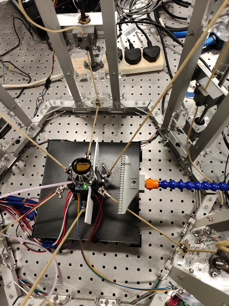 End effector with wind baffles, tracking target, IMU, and gust source in the experimental setup